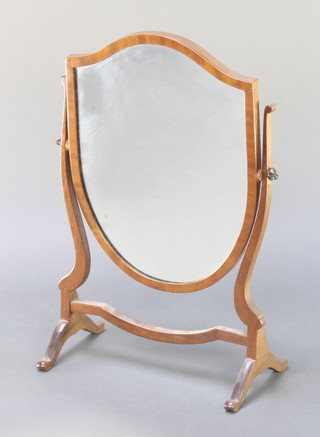 A Sheraton style shield shaped dressing table mirror contained in a mahogany swing frame 23" x 15" 