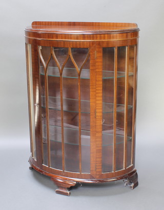 An Art Deco mahogany bow front display cabinet with raised back, fitted shelves enclosed by astragal glazed doors, raised on bracket feet 47"h x 34"w x 14"d 