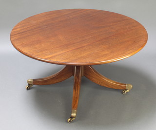 An N Johnson Georgian style circular mahogany pedestal coffee table, raised on pillar and tripod supports ending in brass caps and castors 19"h x 36" diam. 