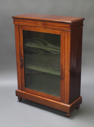 A Victorian inlaid mahogany Pier cabinet, fitted shelves enclosed by a glazed panelled door on a platform base 41"h x 30"w x 12"d  