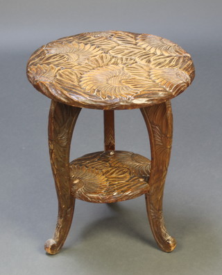 A circular carved Japanese hardwood 2 tier occasional table on outswept supports 18"h x 15" diam. 