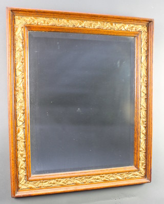 A Victorian rectangular bevelled plate wall mirror contained in an oak and gilt mounted frame with acorn decoration 27"h x 23"w 
