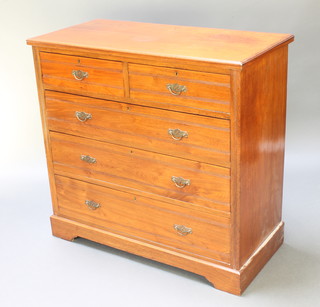 An Edwardian Art Nouveau walnut chest of 2 short and 3 long drawers with brass escutcheons and brass drop handles, raised on a platform base 39"h x 41 1/2"w x 19 1/2"d 