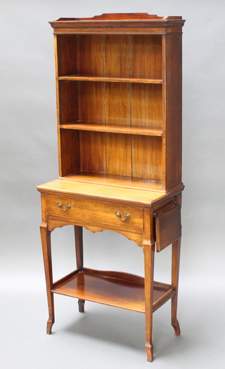 An Edwardian oak bookcase with three-quarter gallery, the upper section fitted shelves, the base fitted 1 long drawer with undertier and 2 flaps to the side, raised on square tapering supports 61"h x 24"w x 13"d 

