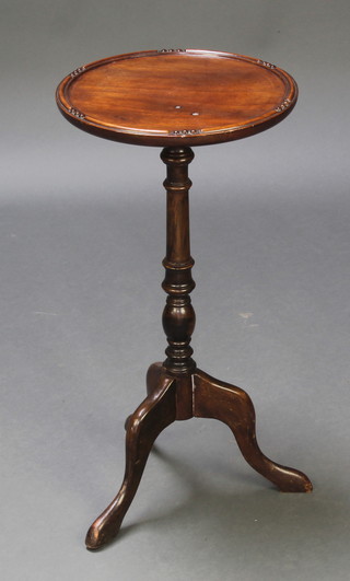 A circular mahogany wine table, raised on a pillar and tripod base 23"h x 12" diam. 