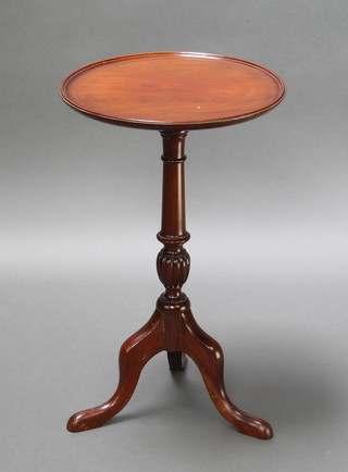 A Georgian style circular mahogany wine table, raised on a pillar and tripod base 24"h x 15" diam.