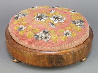 A circular Victorian mahogany footstool, raised on bun feet and with bead work top 3"h x 11 1/2" diam. 