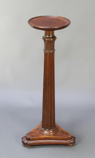 A bedpost torchere with circular dish top and reeded column, raised on a tripod base 31 1/2"h x 10" diam. 