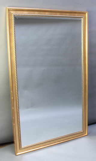 A rectangular bevelled plate wall mirror contained in a decorative gilt frame 6 1/2" x 42" 