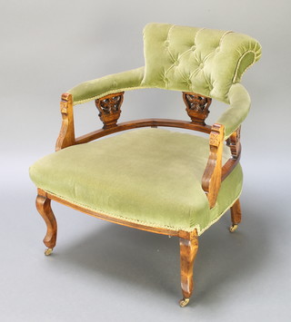 A Victorian carved walnut tub back chair upholstered in green Dralon raised on turned supports