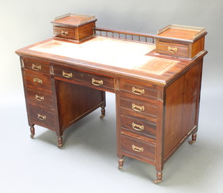 A Victorian Maple & Co mahogany kneehole desk the upper section with gallery fitted 2 short drawers above brown leather inset writing surface, the base fitted 1 long and 8 short drawers 36"h x 46"w x 26"d  