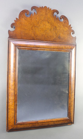 A 17th Century style rectangular plate mirror contained in a walnut cushion shaped frame 38"h x 22"w 