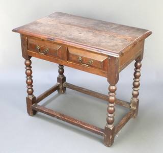 An 18th Century rectangular oak side table, the top formed from 2 planks, fitted 2 long drawers, raised on bobbin turned supports with box framed stretcher 28"h x 32"w x 20"d 