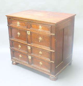 An oak "Jacobean" chest fitted 4 long graduated drawers with brass pear drop handles and geometric mouldings, raised on bun feet 33"h x 35 1/2" x 23"d 