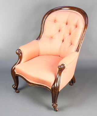 A Victorian mahogany show frame armchair upholstered in pink material, raised on cabriole supports 