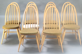 A set of 10 Ercol elm and beech hoop and stick back dining chairs, raised on turned supports with H framed stretchers, bases marked BSLG 19602056