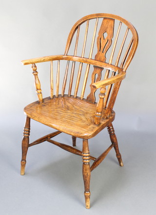 An elm stick back Windsor chair with H framed stretcher, raised on turned supports
