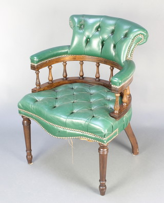 A Victorian style mahogany tub back office chair upholstered in green buttoned leather, raised on turned supports