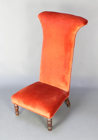 A Victorian mahogany Prie-Dieu chair upholstered in orange material, raised on turned supports 