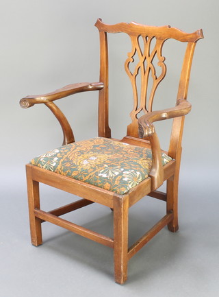 A Georgian mahogany Chippendale style carver chair with pierced vase shaped slat back and upholstered drop in seat, raised on square tapering supports