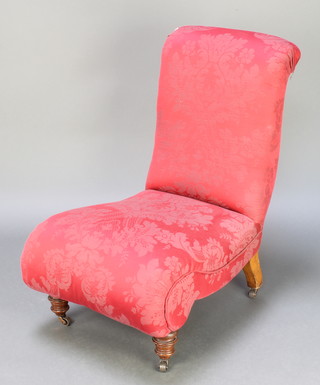 A Victorian nursing chair upholstered in red material 