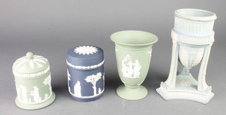A Wedgwood dark blue Jasper circular box and cover decorated with figures, green ditto, pedestal vase and an urn shaped vase 