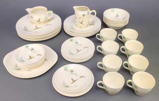 A Royal Doulton The Coppice pattern part tea and dinner service comprising 8 tea cups, 8 saucers, 1 milk jug, cream jug, 6 small plates, 6 medium plates, 7 dinner plates and 6 dessert bowls 