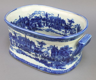 A Victorian style blue and white transfer decorated foot bath decorated with landscape views