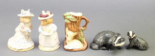 A Beswick figure of a badger 3 1/2", a seated ditto 2 1/4", a Royal Doulton figure - Poppy Eyebright DBH1 4", ditto Mrs Apple DBH3 4" and a china jug 3 1/2" 