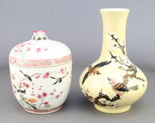 An early 20th Century famille rose pot and cover decorated with birds amongst peony having a peach finial 7" together with a 20th Century Japanese oviform vase decorated with flowers 7 1/2" 
