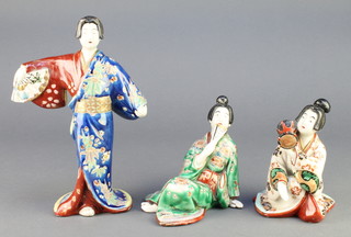 Three early 20th Century Japanese figures of geisha girls - 1 standing 8", 1 seated holding a drum 5" and another seated holding a fan 5" 