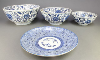 A modern set of 3 Chinese blue and white graduated bowls decorated with flowers and a transfer decorated plate