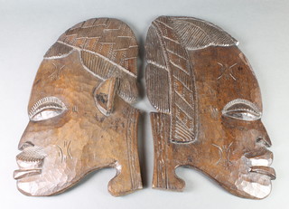 A pair of Congolese carved hardwood portrait plaques in the form of heads 22" x 13" 