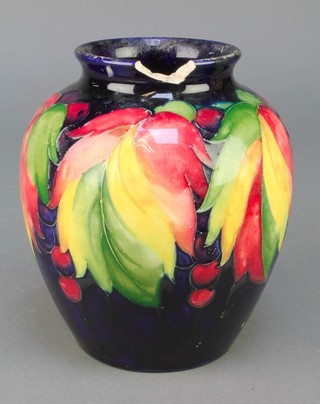 A 1930's William Moorcroft oviform vase decorated with berries and leaves, impressed and painted marks 6" 