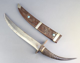 An Eastern dagger with 12 1/2" blade with horn handle, contained in a carved hardwood sheath set turquoise (1 missing) 