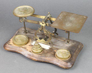 A pair of brass letter scales complete with weights