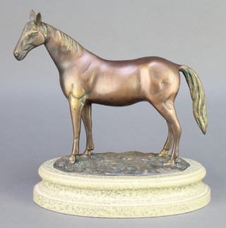 A bronzed figure of a standing horse, raised on an oval polished marble base 11" 