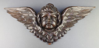 A Victorian carved oak plaque in the form of a cherub's head 21" x 9" (some light chips overall) 