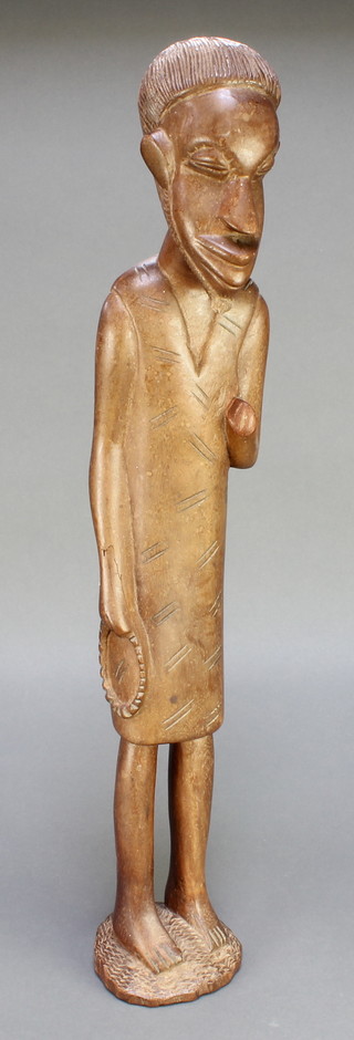 An African carved figure of a standing gentleman 25 1/2" 