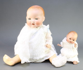 Armand Marseille, a porcelain headed doll with sleep eyes, open mouth with 2 teeth, the head with slot  to back and incised A M Germany 351/6.K. with articulated body 18" and 1 other the head incised 3T/.76 with sleep eyes and open mouth with 2 teeth 9" 