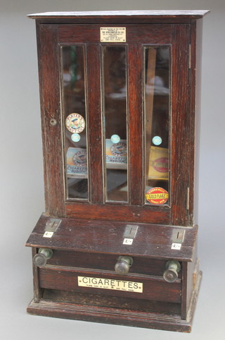 A 1930's oak wall mounted 3 brand cigarette dispensing machine contained in an oak case with plaque marked This machine is the sole property of the Hyde-Simplex Company Ltd 27"h x 15"w x 11"d , unlocked, (no key)