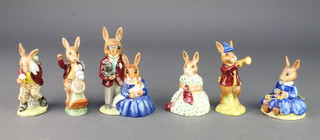 A collection of Royal Doulton Bunnykins figures - Rise and Shine DB11 4", Family Photograph DB1 4 1/2", Busy Needles DB10 3 1/4", Spring Time DB7 3", Tally Ho DB12 4" and Cooling Off DB3 4"