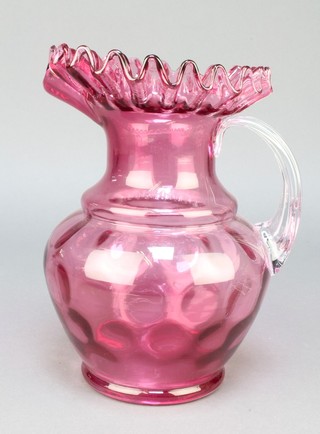 A Victorian cranberry ware jug with clear fluted glass handle 9" 