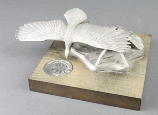 From the estate of Captain Eric M Brown, A A White, a metal desk ornament in the form of bald eagle inset a coin to commemorate the 1985 Paris Air Show induction of the H-76 Eagle May 1985 