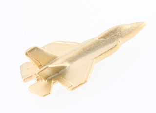 From the estate of Captain Eric M Brown a gilt pin in the form of an F-35 Fighter Jet