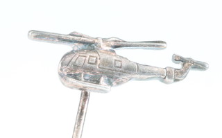 From the estate of Captain Eric M Brown a white metal pin in the form of a helicopter