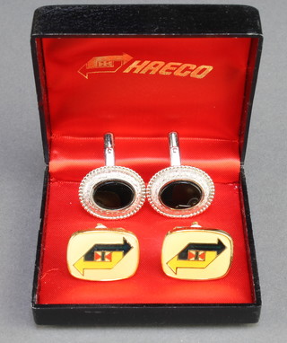 From the estate of Captain Eric M Brown a pair of HAECO (Hong Kong Aircraft Engineering Company)  gilt metal cufflinks, boxed together with a pair of white metal and "onyx" set cufflinks 
