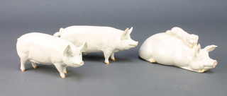 Three Beswick figures of pigs - C H Wall Queen 40 6", C H Wall C H Boy 53 6 1/2" and a reclining sow and piglet 6 1/2" 