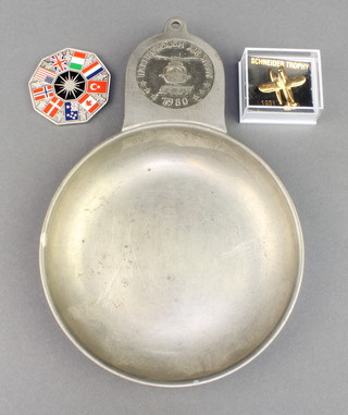 From the estate of Captain Eric M Brown a circular pewter dish to commemorate the 1980 Farnborough Air Show, a gilt metal lapel pin in the form of a Supermarine Seaplane S6B to commemorate the 75th Anniversary of The Schneider Trophy together with a white metal and enamelled medallion to commemorate the First Flight of the F-35 Lighting II