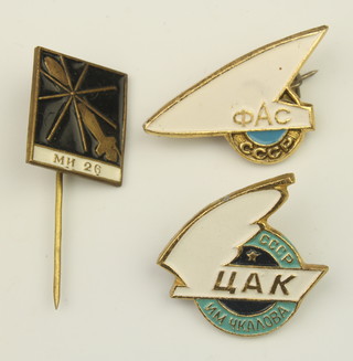 From the estate of Captain Eric M Brown a Soviet Russian gilt metal enamelled lapel pin decorated an MN26 helicopter, a gilt metal and enamelled CCP pin marked UAK, 1 other marked 0AC